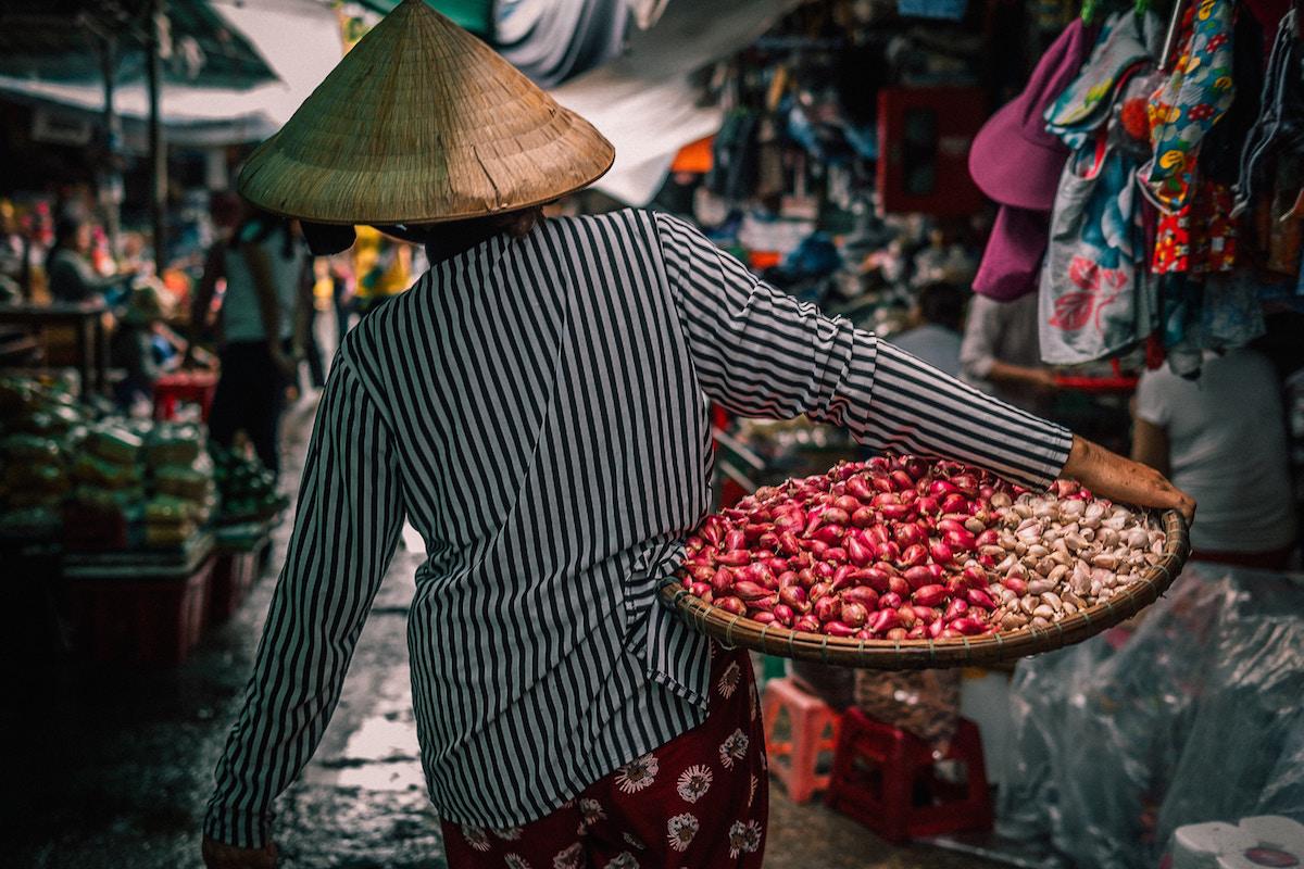 Woman carrying vegetables to the market