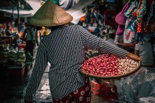 Woman carrying vegetables to the market