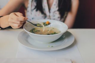 Woman eating a soup